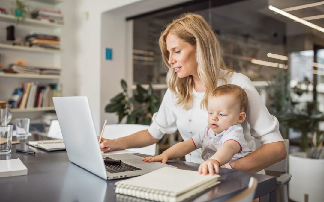 Single mother with baby working in office